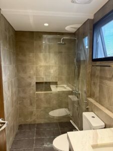 Modern bathroom with rain shower and full glass enclosure in Ayala Alabang property