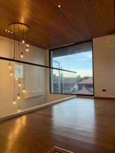 Loft-style family den with pendant lights and wood flooring in upscale Muntinlupa home